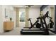 Bright home gym with exercise equipment, natural light, and modern decor for a comfortable workout space at 11857 Blue Diamond Trl, Parrish, FL 34219