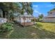 A backyard featuring the deck, mature trees providing shade and privacy at 1210 E Sligh Ave, Tampa, FL 33604