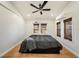 Bright bedroom showcasing hardwood floors, bamboo shades, and a modern ceiling fan at 1210 E Sligh Ave, Tampa, FL 33604