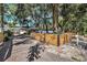 A long driveway leading to the home with a fence and mature trees in the background at 1210 E Sligh Ave, Tampa, FL 33604