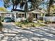 Charming one-story home with carport, covered porch and white picket fence at 1210 E Sligh Ave, Tampa, FL 33604