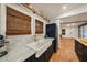 This kitchen features marble countertops, a farmhouse sink, and stainless steel appliances at 1210 E Sligh Ave, Tampa, FL 33604