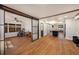 Open-concept living space with hardwood floors, sliding doors, and an island connecting the kitchen to other rooms at 1210 E Sligh Ave, Tampa, FL 33604