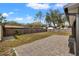 Fenced backyard with a shed and paved patio area at 1314 Oak Valley Dr, Seffner, FL 33584