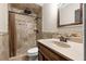 Bathroom features a tile shower, decorative tile backsplash, and a dark wood vanity at 1314 Oak Valley Dr, Seffner, FL 33584