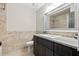 Bathroom with granite vanity, large mirror, and stone flooring at 1314 Oak Valley Dr, Seffner, FL 33584