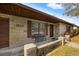 A close-up of a cozy front porch with bench featuring a stone facade and well-maintained lawn at 1314 Oak Valley Dr, Seffner, FL 33584