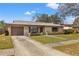 Charming single-story home featuring a stone facade, well-maintained lawn, and a cozy front porch at 1314 Oak Valley Dr, Seffner, FL 33584