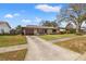 Quaint single-story home featuring a stone facade, well-maintained lawn, and a long driveway at 1314 Oak Valley Dr, Seffner, FL 33584