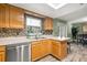 Kitchen with wooden cabinets, stainless steel dishwasher, and a sink with a window view at 1314 Oak Valley Dr, Seffner, FL 33584