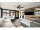 Enclosed sunroom with wood paneled accent wall, sectional couch, and multiple windows for natural light at 1314 Oak Valley Dr, Seffner, FL 33584