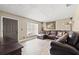 Spacious living room featuring hardwood floors, a large window, and a comfortable brown leather sectional sofa at 1314 Oak Valley Dr, Seffner, FL 33584