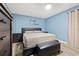 Bedroom with blue walls, dark wood furniture, and a modern decorative saying on the wall at 1314 Oak Valley Dr, Seffner, FL 33584