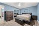 Bedroom with blue walls, dark wood furniture, and a sliding door closet with mirrored doors at 1314 Oak Valley Dr, Seffner, FL 33584