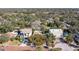 Aerial view of a property with a large metal workshop building surrounded by mature trees in a residential area at 1545 Pasadena Dr, Dunedin, FL 34698