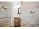 Modern bathroom featuring tiled shower with glass door and a vanity with modern fixtures at 1545 Pasadena Dr, Dunedin, FL 34698