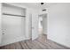 Bright bedroom featuring wood-look flooring, a built-in closet, and natural light at 1545 Pasadena Dr, Dunedin, FL 34698