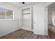 Bright bedroom featuring wood-look flooring, a built-in closet, and natural light at 1545 Pasadena Dr, Dunedin, FL 34698