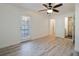 Bedroom featuring wood-look flooring, a ceiling fan, and a door to the backyard at 1545 Pasadena Dr, Dunedin, FL 34698