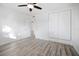 Bright bedroom featuring wood-look flooring, a built-in closet, and natural light at 1545 Pasadena Dr, Dunedin, FL 34698