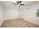 Bright bedroom featuring wood-look flooring, a mini-split AC, and natural light at 1545 Pasadena Dr, Dunedin, FL 34698