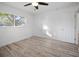 Bright bedroom featuring hardwood floors, a window allowing natural light, and neutral paint at 1545 Pasadena Dr, Dunedin, FL 34698