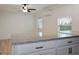 Kitchen with granite countertops, modern ceiling fan, and adjacent open living space at 1545 Pasadena Dr, Dunedin, FL 34698