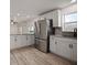 Well-lit kitchen features stainless steel refrigerator and granite countertops at 1545 Pasadena Dr, Dunedin, FL 34698