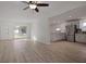 Bright and airy living room with hardwood floors and open layout to the modern kitchen at 1545 Pasadena Dr, Dunedin, FL 34698