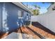 A well-maintained side yard with a modern AC unit and white privacy fence provides a secure space at 1545 Pasadena Dr, Dunedin, FL 34698