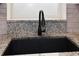 Close-up of kitchen sink with granite countertops and modern faucet fixture at 1545 Pasadena Dr, Dunedin, FL 34698