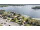 Aerial view of lakefront property with dock and mature landscaping at 2050 W Bearss Ave, Tampa, FL 33618