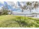 Beautiful waterfront property with a well-maintained lawn leading to a private dock, perfect for lake access at 2050 W Bearss Ave, Tampa, FL 33618