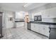 Kitchen with stainless steel appliances, tile flooring, and white cabinets at 2050 W Bearss Ave, Tampa, FL 33618