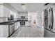 Well-lit kitchen with stainless steel appliances, granite countertops, and sleek white cabinetry at 2050 W Bearss Ave, Tampa, FL 33618