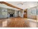 Cozy living room featuring hardwood floors, a stone fireplace, and rustic wood beam accents at 2050 W Bearss Ave, Tampa, FL 33618