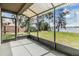 Enclosed screened porch offers serene lake views and a peaceful outdoor retreat at 2050 W Bearss Ave, Tampa, FL 33618