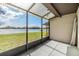 Enjoy tranquil lake views from this covered and screened-in outdoor space at 2050 W Bearss Ave, Tampa, FL 33618