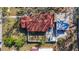 An aerial view displays a house with a red roof, a white fence, and a compact yard at 2111 26Th S St, St Petersburg, FL 33712