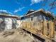 View of backyard featuring garage, wooden deck, and privacy fence at 2111 26Th S St, St Petersburg, FL 33712