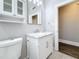 Well-lit bathroom with a marble vanity top, a mirrored wall cabinet, and a modern toilet at 2111 26Th S St, St Petersburg, FL 33712