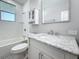 Bathroom with white subway tile, a marbled vanity, and a window above the bathtub at 2111 26Th S St, St Petersburg, FL 33712