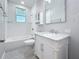 Bathroom with white subway tile, a marbled vanity, and a window above the bathtub at 2111 26Th S St, St Petersburg, FL 33712