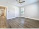 Bedroom featuring new dark wood floors, a ceiling fan, and a bright window at 2111 26Th S St, St Petersburg, FL 33712