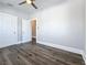 Bright bedroom featuring new dark wood floors, a ceiling fan, and several doors at 2111 26Th S St, St Petersburg, FL 33712