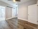 Bright bedroom with barn door to closet and ensuite bathroom, featuring modern flooring and neutral walls at 2111 26Th S St, St Petersburg, FL 33712