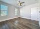 This bedroom showcases a modern ceiling fan, two windows, neutral walls, and sleek flooring at 2111 26Th S St, St Petersburg, FL 33712