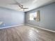 Spacious bedroom featuring wood-look tile, ceiling fan, and a window for natural light at 2111 26Th S St, St Petersburg, FL 33712