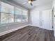 Bedroom with new dark wood floors and a large window that provides natural light at 2111 26Th S St, St Petersburg, FL 33712