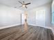 Bright bedroom featuring new dark wood floors, a ceiling fan, and white trim at 2111 26Th S St, St Petersburg, FL 33712